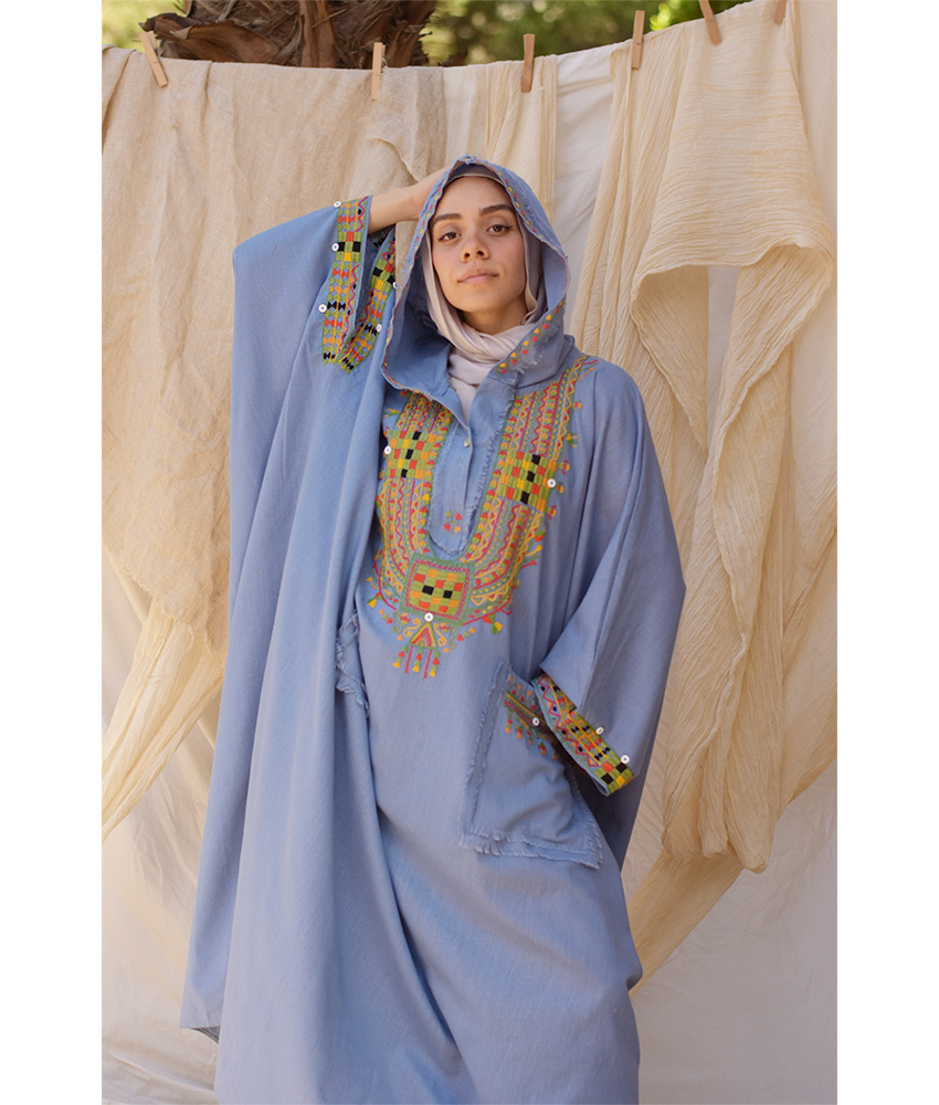 Denim blue Siwa Embroidered Linen Kaftan with Hoodie handmade in Egypt & available at Jozee Boutique.